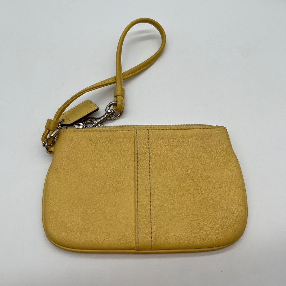 21. Coach Yellow Leather Zip Top Wristlet